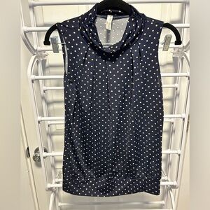 Sleeveless blue turtleneck with tan polka dots